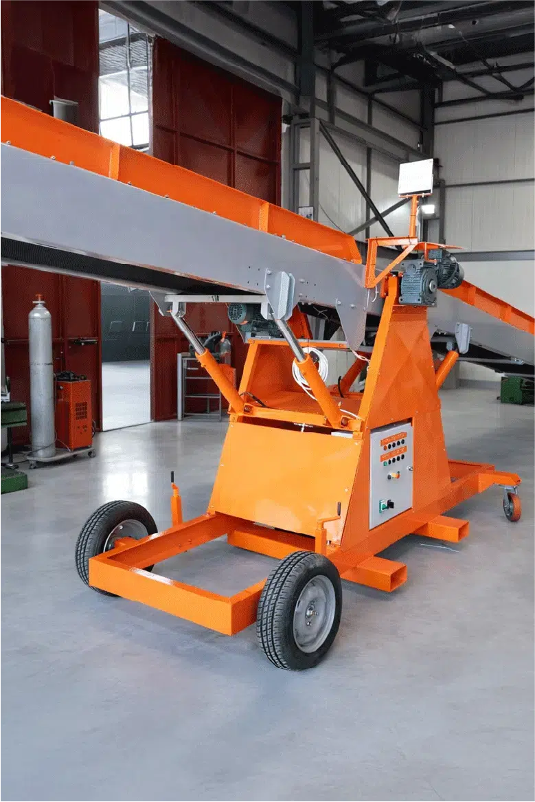 Mobile orange belt conveyor with adjustable incline, hydraulic lifting system, and wheeled base inside an industrial workshop.