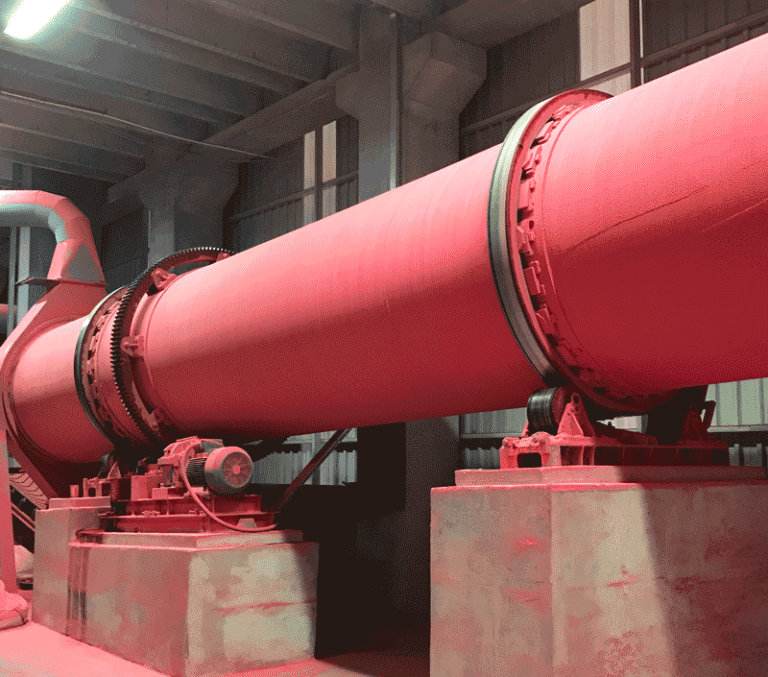 A red rotary industrial machine in a factory
