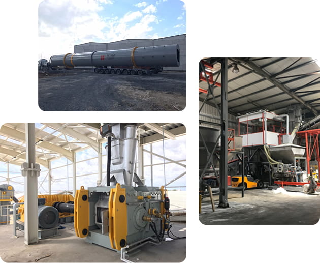 Large industrial rotary drum loaded on a multi-axle trailer outside a factory